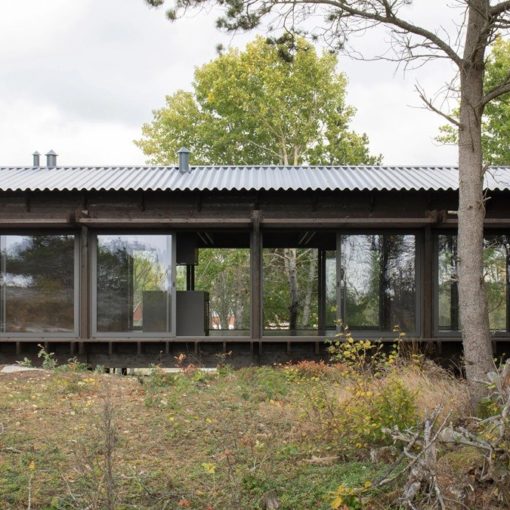 House Tjurpannan with Tar-Coated Black Timber Exterior by HelgessonGonzaga
